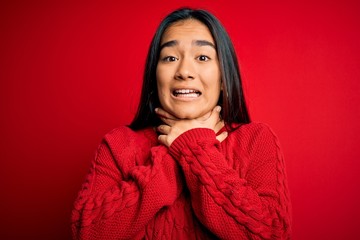 Sticker - Young beautiful asian woman wearing casual sweater standing over isolated red background shouting and suffocate because painful strangle. Health problem. Asphyxiate and suicide concept.