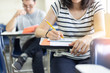 © panitan - high school,university student study.hands holding pencil writing paper answer sheet.sitting lecture chair taking final exam attending in examination classroom.concept scholarship for education abroad