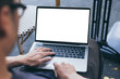 © panitan - computer mockup image blank screen with white background for advertising text,hand woman using laptop contact business search information on desk at coffee shop.marketing and creative design
