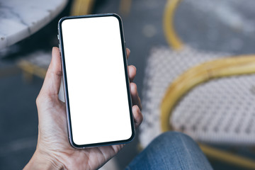 cell phone Mockup image blank white screen.woman hand holding texting using mobile on desk at coffee shop.background empty space for advertise text.people contact marketing business,technology