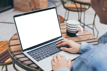 computer mockup image blank screen with white background for advertising text,hand woman using laptop contact business search information on desk at coffee shop.marketing and creative design