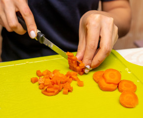 Sticker - Girl cuts boiled carrots with a knife