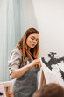 © Екатерина Рукосуева - A young woman painstakingly draws her picture with brushes on easels in an art class. learning to draw , art school, creativity and the concept of people