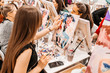 Young women paint with brushes on easels in art class. art school, creativity and people concept