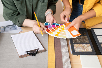 Poster - Hands of two young female interior designers consulting about choice of color
