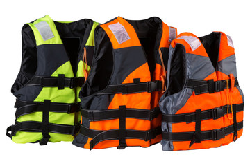 three life jackets stand in a row, two orange and one green vest, concept, on a white background