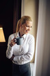 © JustLife - Young beautiful woman enjoying in coffee.Businesswoman working from a hotel room.
