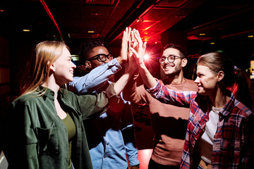 Sticker - Group of young cheerful intercultural friends giving each other high five