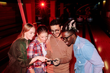 Sticker - Group of happy young intercultural friends scrolling through their photos