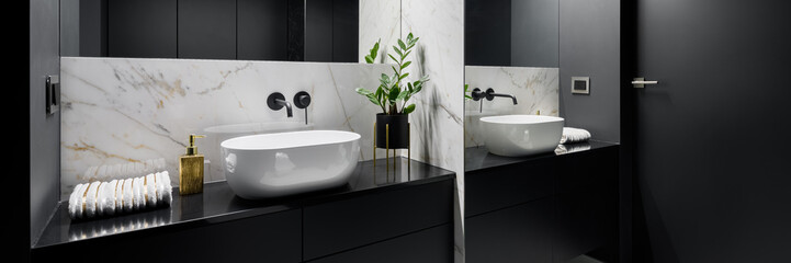 Black bathroom with mirror wall, panorama