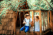 Little boy and girl playing in treehouse at forest park, Active kids on playground, Child enjoying activity in a climbing adventure park on summer sunny day. Ecological playground