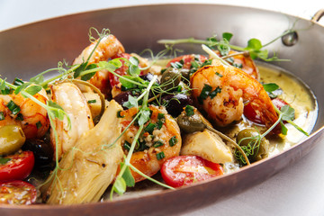 Wall Mural - Grilled prawns shrimps with vegetables in a metal bowl, closeup, horizontal