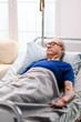 © DC Studio - Retired old man in nursing home laying on bed