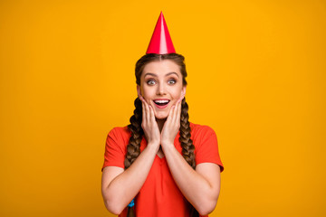 Sticker - Photo of attractive funny lady hold hands cheeks weekend good mood unexpected birthday party wear paper cone cap casual red t-shirt isolated vibrant yellow color background