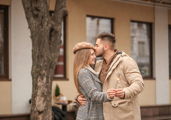 Poster - Happy young couple with sparklers outdoors