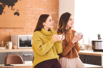 Sticker - Young women drinking tea in kitchen