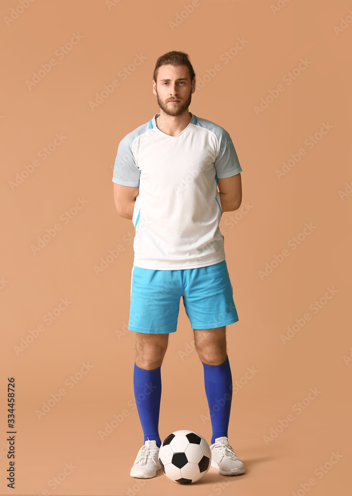 Male football player on color background