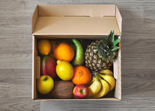 Fresh Fruit Delivery Box On Parquet Floor