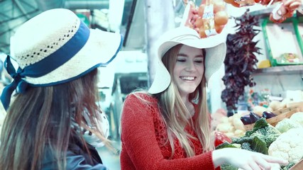 Sticker - Young blonde woman selecting fruits at the market. Slow motion footage