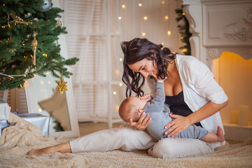 mother hug newborn son lights