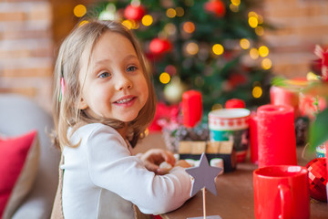 little girl smiling near christmas tree