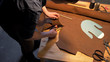 © iaginzburg - Man cuts a piece of cloth on a table