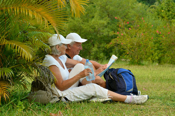 Poster - Portrait of elderly couple of tourists with map