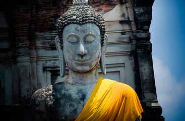 Buddha statue with yellow fabric in Temple of Thailand.