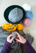 Woman's hands crochet background.  Looking down on Woman's hands  Crocheting blanket out of light blue yarn