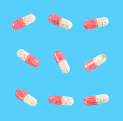 Wall Mural - medical capsules on a clear blue background