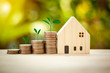 © Mongkol - House model and coins stack with tree on sun light bokeh background mortgage for saving concept, build home and business for the future.