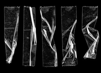set of transparent adhesive tape or strips isolated on black background, crumpled plastic sticky sni