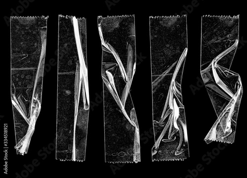 Fotomural set of transparent adhesive tape or strips isolated on black background, crumpled plastic sticky snips, poster design overlays or elements