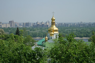 Golden domes of Kiev Pechersk Lavra on the background of the left bank of the Dnieper in Kiev