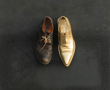Concept Of Rich And Poor In A Shoes, Old And Golden Shoe