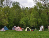 Fototapeta  - Tents near the forest, in summer people rest in a tent camp, trekking
