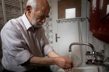 Very Old Turkish Man Washing His Hands In His Vintage Bathroom
