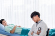 © Anatta_Tan - Asian male doctor Sitting and close his eyes on the chair, he watched the symptoms of the patients Who were sleeping and receiving treatment. to health care and insurance concept.