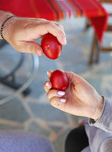 Hands Holding Cracked Red Easter Eggs - Orthodox Greek Tradition Of Cracking Eggs - Symbolizes Christ Resurrection