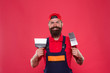 © be free - Professional plasterer. Skillful plasterer. Successful renovation. Repair success. Bearded man worker with plastering tools. Plasterer hipster builder in cap red background. Interior designer