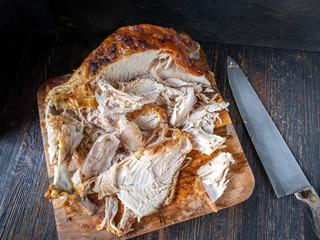 Wall Mural - sliced baked golden brown turkey meat on cutting board