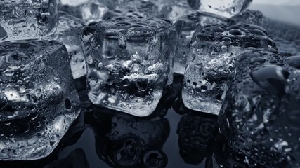 Wall Mural - Wet melted ice cubes with waterdrops. Ice super macro. Slider shot, 4K