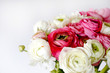 Macro shot of beautiful bouquet of pink & white ranunculus flowers with visible petal texture . Close up composition with bright patterns of flower buds with a lot of copy space for text. Top view.