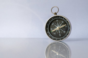 compass on light background with copy space using as direction