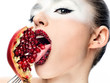 face of a young girl with pomegranate