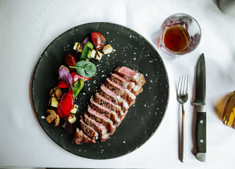 Wall Mural - Beef tagliata, meat, with potatoes and tomatoes and herbs, top view, square