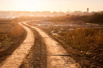 Fotomurales - Landscape of a dirt road near a city
