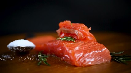 Wall Mural - slice of salty red fish on a fork, wooden background