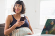 © Sam Edwards/Caia Image - Happy pregnant woman using smart phone
