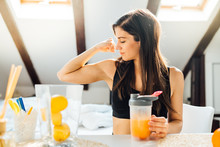 Woman At Home Drinking Orange Flavored Amino Acid Vitamin Powder.Keto Supplement.After Exercise Liquid Meal.Weight Loss Fitness Nutrition Diet.Immune System Support.Organic Citrus Fruit.Strong Body